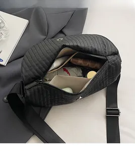 Macro view of large capacity quilted shoulder bag showing spacious interior compartment