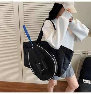 Detail of black sports tote with racket compartment and small Grey-white coin pouch