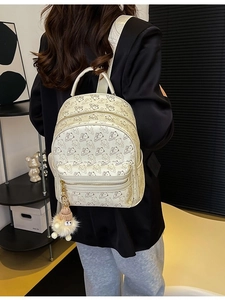 Beige PU leather backpack with bear print and plush pendant, stylish travel rucksack for women