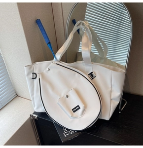 White faux leather tote bag detail with dedicated racket pocket and silver buckle