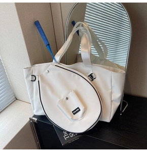 Detail of white sports tote bag with a functional badminton racket pocket and snap pocket