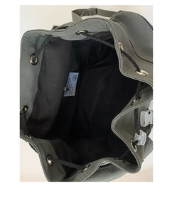 Detailed interior of nylon drawstring backpack with metal eyelets and designer label