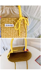 Close-up of woven straw bucket bag featuring yellow handles and On Our Own fabric label