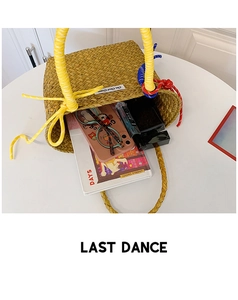 Detail view of woven straw tote bag showing spacious interior with color rope handles