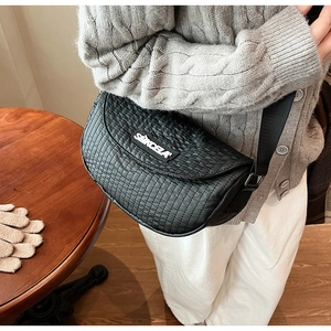 Close-up of black quilted crossbody bag showing vertical stitching and SIMCELA logo