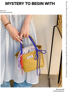 Detail of hand-woven straw bag with colorful cotton rope handles and drawstring liner