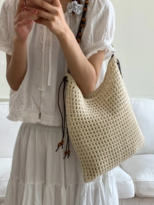 Chic beige crochet tote bag with wooden bead shoulder strap and hollow mesh design