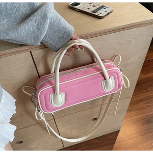 Detail of pink and beige bowling bag with bow decoration and detachable shoulder strap