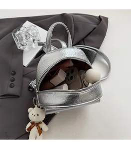 Silver mini leather backpack interior showing space for phone and cosmetic items
