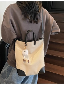 Large cream canvas tote bag with black leather trim and cute pompom charm detail
