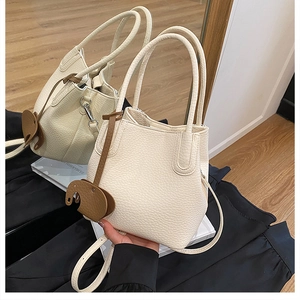 Sac seau blanc cassé avec pendentif éléphant marron et bandoulière réglable en détail