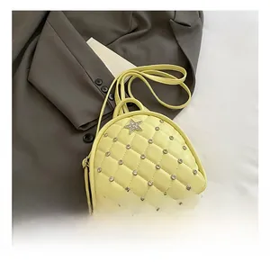 Detail of yellow quilted mini backpack with rhinestone stars on grey blazer