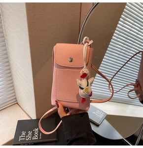 Pink lychee texture crossbody phone bag with cute white duck charm accessory