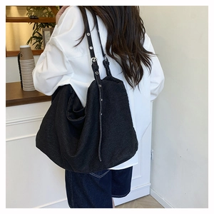 Fashionable black denim tote bag with adjustable metal eyelet strap for women