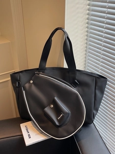 Black sporty tote bag with matching racket cover featuring elegant white contrast piping