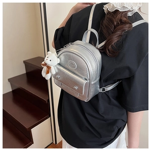 Silver mini backpack featuring crinkled faux leather and cute white bear keychain