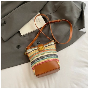 Top view of a woven bucket bag with colorful stripes and gold hardware details