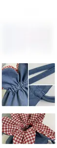 Detail view of denim drawstring bag with YES HONEY embroidery and red gingham lining