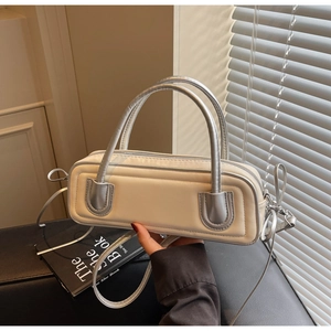 Detail of cream white bag showing silver metallic handles and side bow drawstring knots