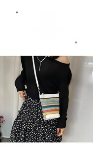 Detail of colorful rainbow woven crossbody bag with white leather trim and silver metal zip