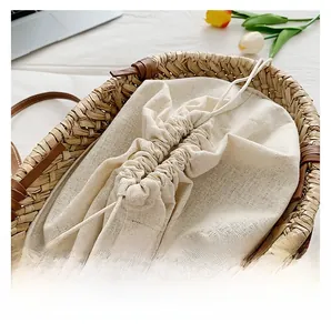 Detail of straw bucket bag with beige drawstring lining and natural woven texture