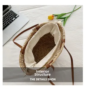 Detail of straw bucket bag featuring a secure drawstring lining and brown leather straps