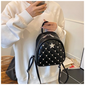 Detail view of mini black quilted backpack with sparkly star and rhinestone accents