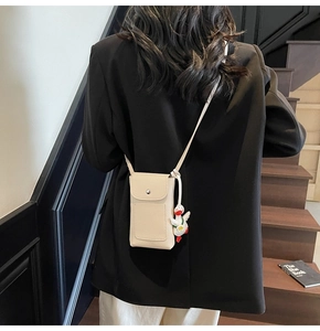 Beige litchi grain phone bag featuring a cute white duck pendant and metal snap closure
