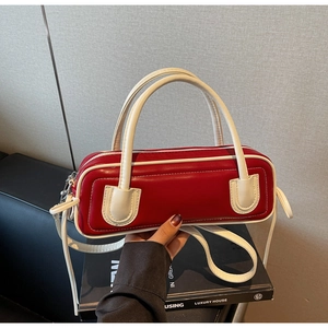 Detailed shot of a red and white contrast baguette bag with adjustable shoulder strap