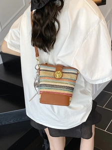 Multicolor woven bucket bag with brown leather trim and golden clasp for summer fashion