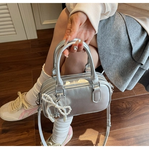 Silver oil wax leather boston bag with pearl bow charm and adjustable strap