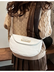Minimalist white quilted saddle bag with wide adjustable shoulder strap for women