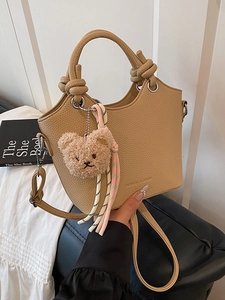 Chic khaki pebbled leather bucket bag with knot handle and plush bear charm for women