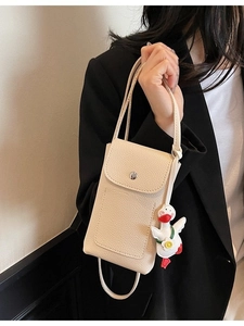 Minimalist cream crossbody phone bag with pebble leather texture and duck charm decoration