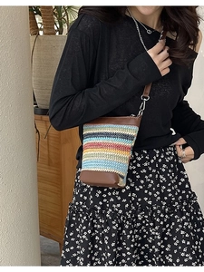 Colorful striped woven crossbody phone bag with brown leather trim and shoulder strap