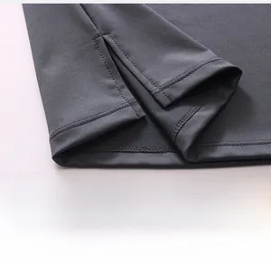Close-up of slit hem and reinforced double stitching on men's compression fitness vest