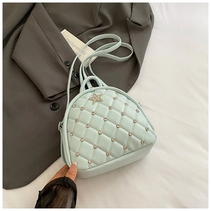 Detail of mint green quilted backpack with rhinestone star decor and silver studs