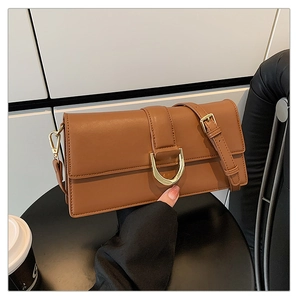 Détail du sac bandoulière marron caramel avec boucle dorée en D et bandoulière ajustable