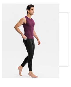 Detail view of purple compression vest and black leggings with a side phone pocket