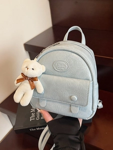 Light blue mini backpack with crinkled texture, fashion logo and cute bear charm pendant