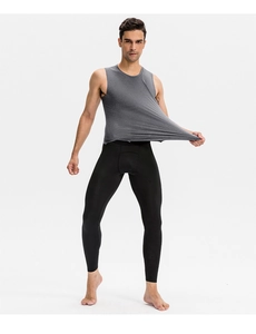 Detail shot of the high-stretch grey compression tank top showing elastic fabric flexibility