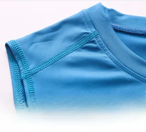 Close-up of shoulder seam and blue moisture-wicking fabric on men's athletic vest