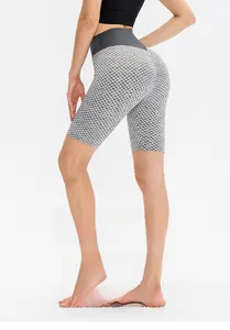Detail showing grey honeycomb texture high waist fitness shorts with scrunch butt effect