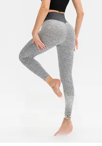 Detail of high waisted honeycomb textured leggings showing push up effect on gray fabric