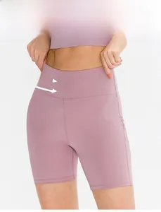 Detail of high waisted yoga shorts showing peach lift design and seamless stitching