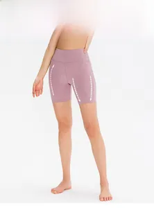 Detail view of high-waisted yoga shorts in dusty rose featuring tummy control and butt lift