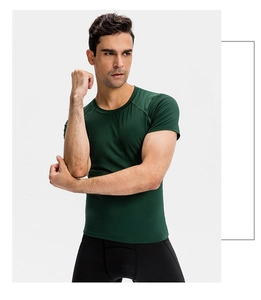 Detail of dark green compression t-shirt showing raglan sleeves and athletic muscle fit