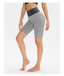 Detail of high-waisted yoga shorts featuring grey honeycomb textured fabric and lifting seam