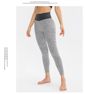 Detailed macro view of honeycomb texture fabric and wide black high waistband on yoga leggings