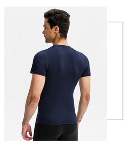 Rear view of men's compression fitness shirt showing tight fit and elastic dark blue fabric